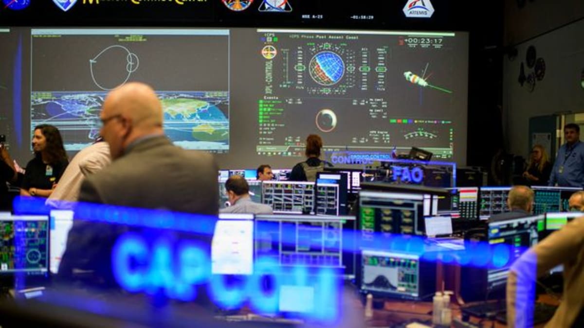 Modern NASA Mission Control Center in Houston with computer monitors and diverse team members
