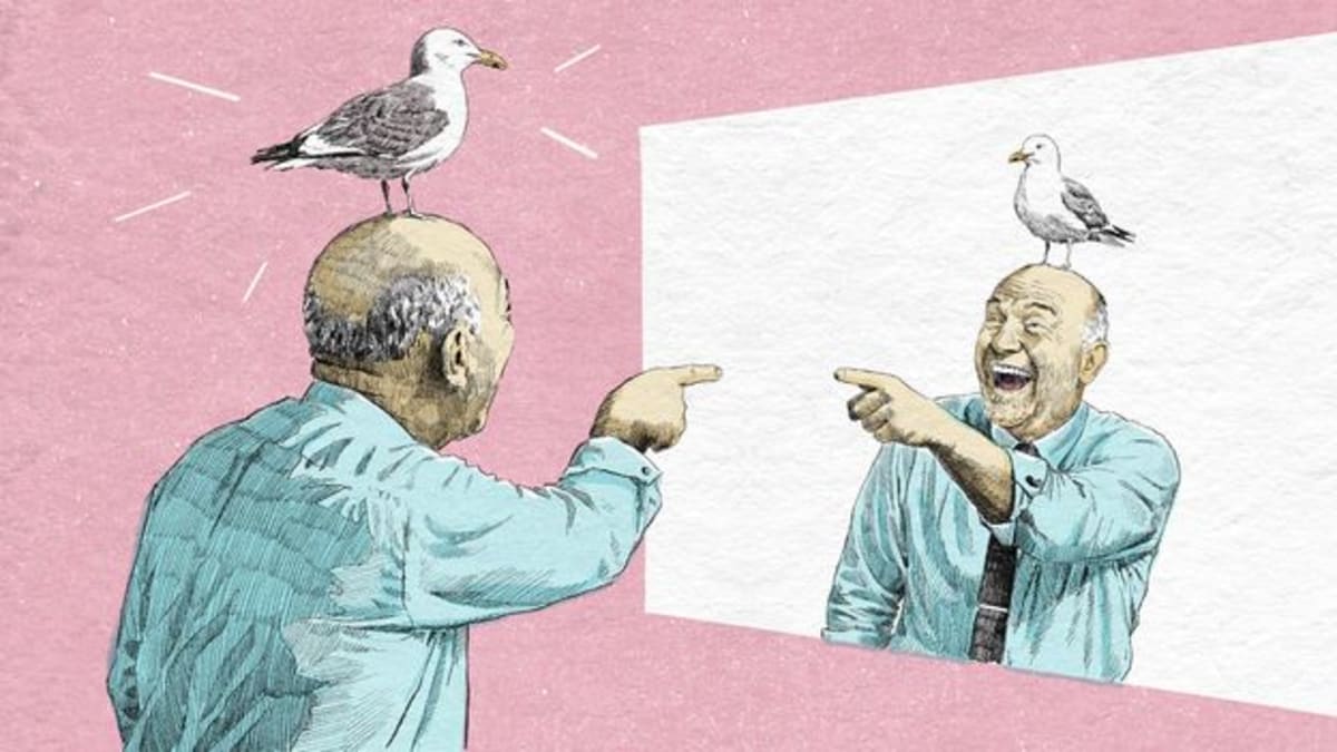 Person smiling while looking at their reflection in a fun-house style distorted mirror