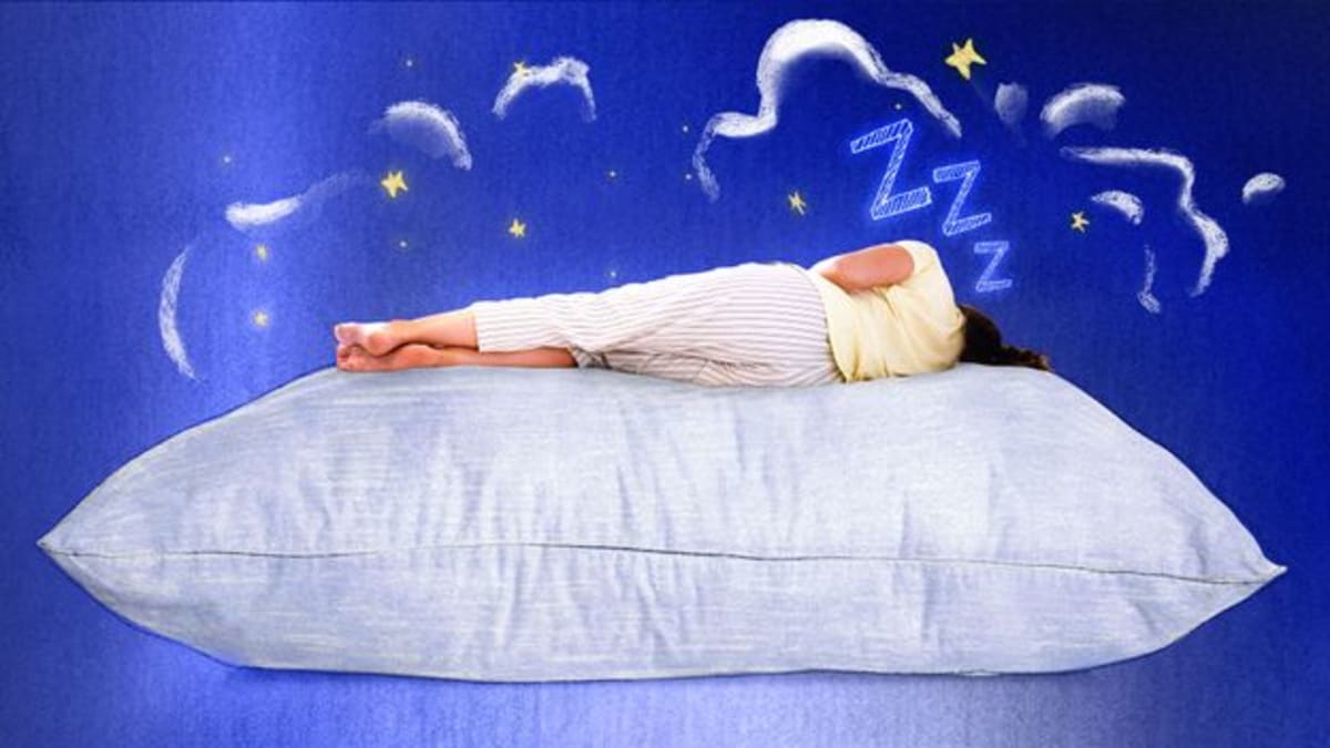 Person sleeping peacefully on pillow against serene blue night sky background