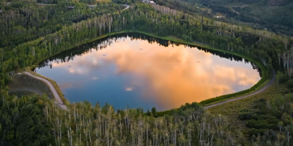 Ziegler Reservoir in Snowmass Village surrounded by mountain peaks and wilderness landscape