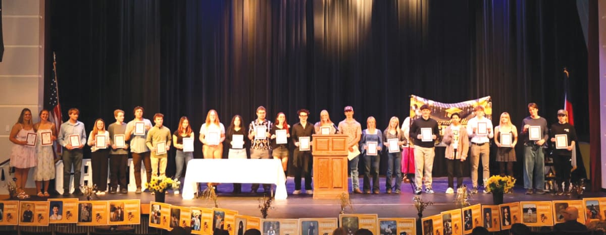 Gilpin County High School Class of 2026 graduates standing together on stage during scholarship awards ceremony