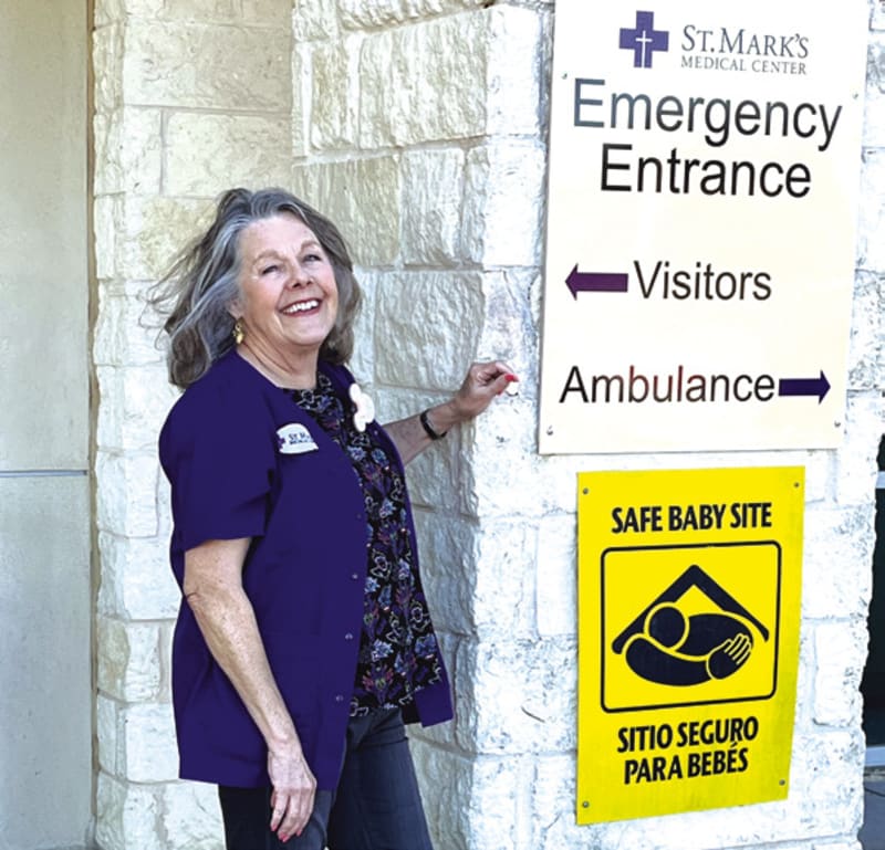 ** Group of Purple Angels hospital volunteers in purple uniforms standing together smiling at camera
