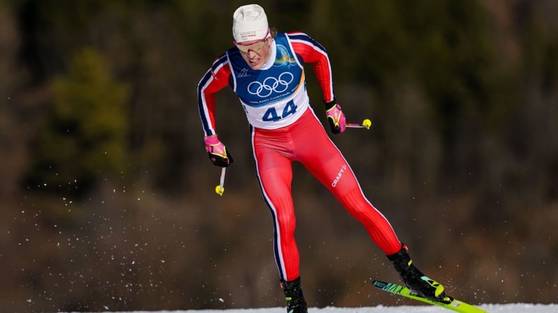 Norwegian cross-country skier Johannes Klaebo celebrating gold medal victory at finish line