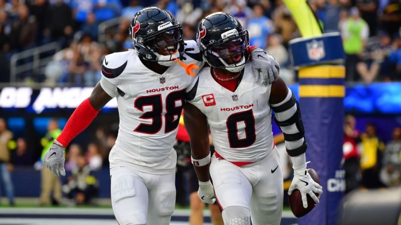 NFL defensive players from Texans, Broncos, and Seahawks celebrating together during playoff game action
