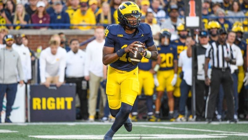 Michigan quarterback Bryce Underwood in maize and blue uniform celebrating during a college football game