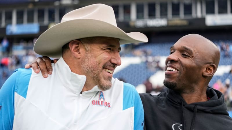 DeMeco Ryans and Mike Vrabel standing on sidelines coaching their NFL teams during playoff games