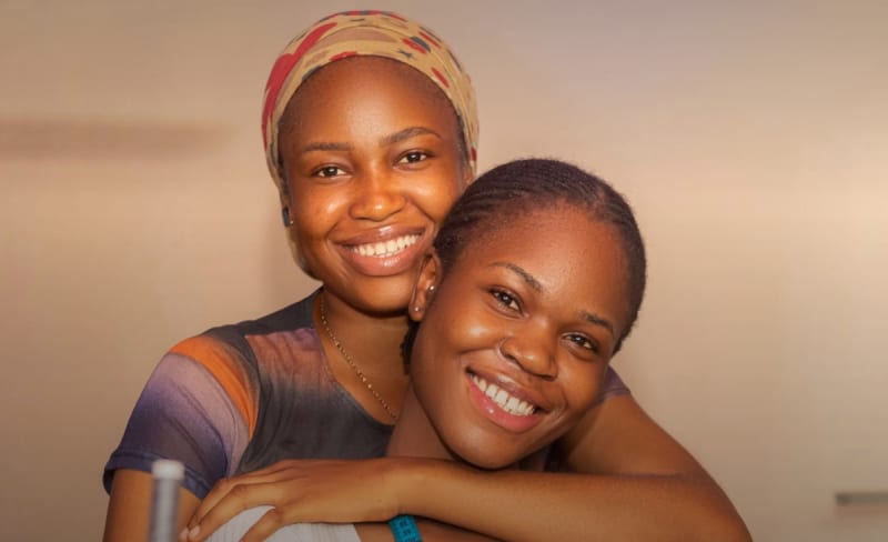 African woman fashion designer working with colorful fabrics in bright creative studio workspace