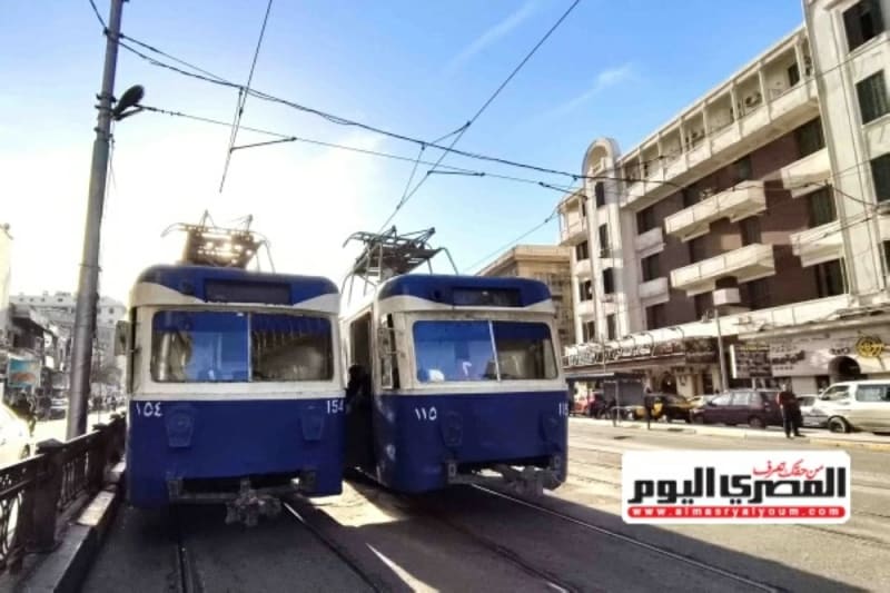 Modern tram on tracks in Alexandria, Egypt with passengers waiting at station platform