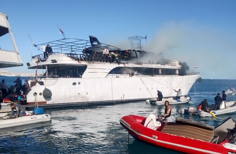 Fire trucks and emergency vehicles responding to boat fire at Hurghada beach resort area