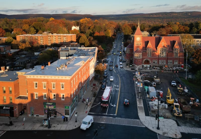Middle school students playing basketball and exercising together in gymnasium before school starts