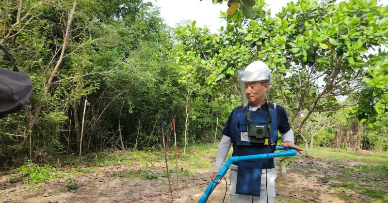 Retired South Korean Army colonel Jeong Tae-seong inspecting mine clearance equipment in Cambodia