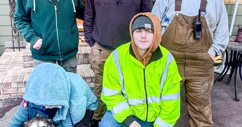 Rescue squad members with ropes standing on icy hillside after saving stranded dog Bailey