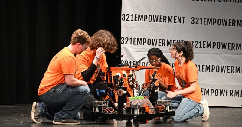 Students performing on stage at Lift Every Voice Youth Showcase in Rockledge High School auditorium