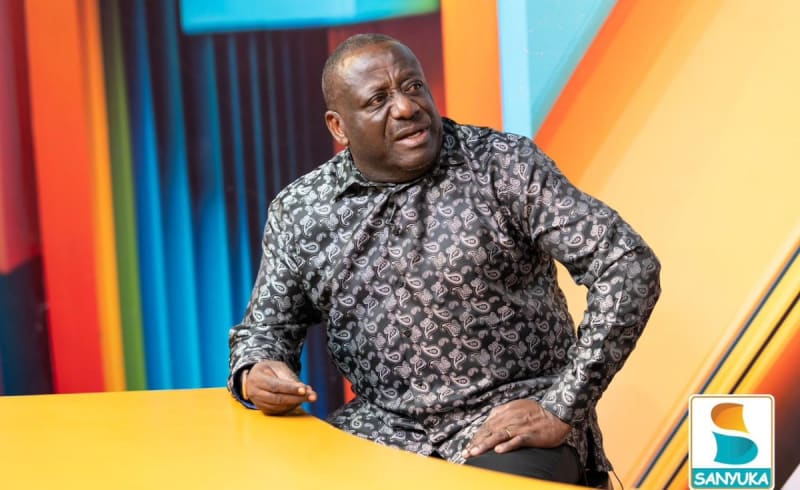 Uganda Communications Commission officials working collaboratively in modern office managing national digital infrastructure and connectivity systems