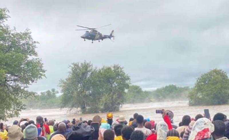 Community health worker assisting pregnant woman in rural South African village home