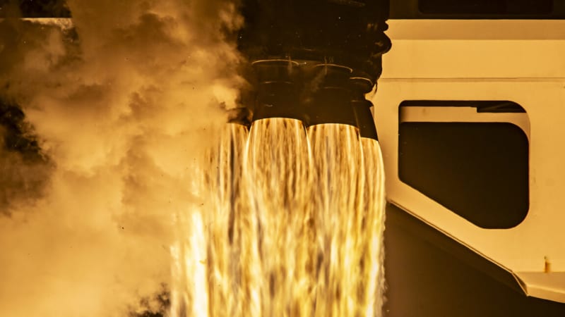 Seven smiling astronauts floating together inside the International Space Station after crew reunion