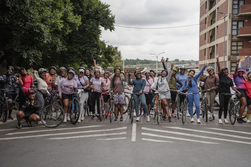 Group of women cyclists riding together through Johannesburg streets, led by founder Karabo Mashele
