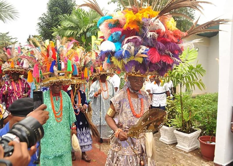 Obi Cubana in traditional Igbo attire receiving chieftaincy title at colorful Ofala Festival ceremony