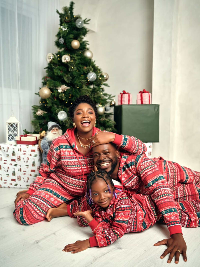 Nigerian music couple Adekunle Gold and Simi with their daughter in a warm family portrait celebrating new twins
