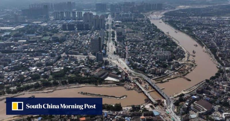 Aerial view of massive Pinglu Canal construction winding through green mountainous terrain in Guangxi China