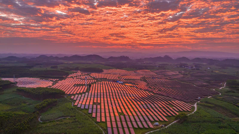 Aerial view of large solar farm panels integrated with agricultural land in China
