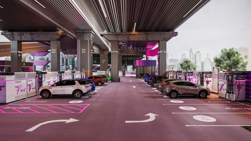 Modern electric vehicle charging station with multiple stalls and battery storage units in urban Brooklyn setting