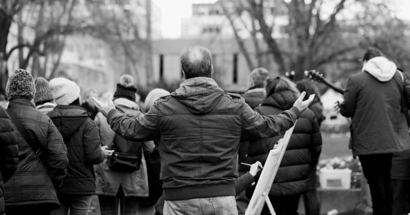 Diverse group of clergy members singing together during peaceful protest in Minneapolis