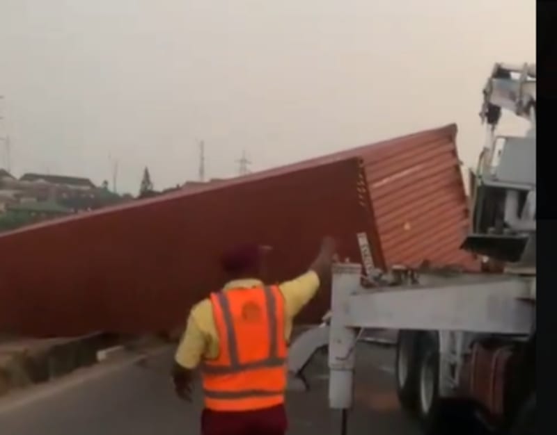 Overturned container truck being stabilized by Lagos traffic rescue team during midnight operation