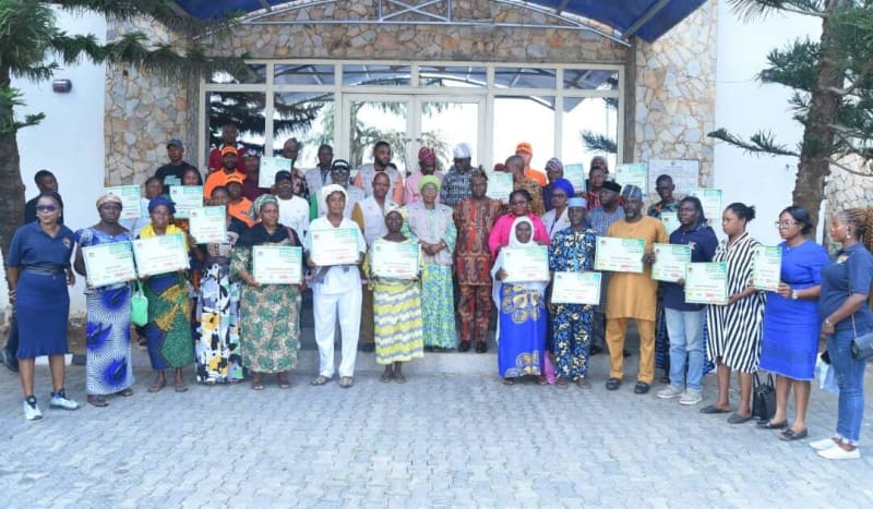Deputy Governor Christiana Afuye standing with fire disaster beneficiaries holding checks in Ado Ekiti