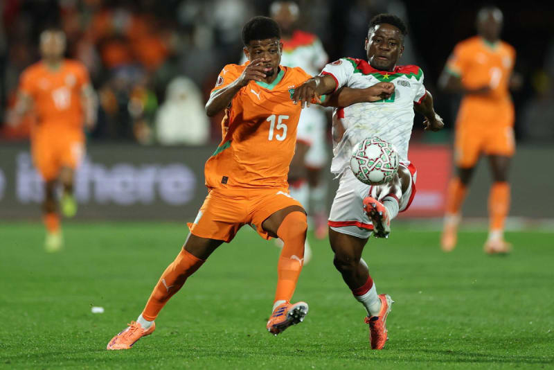 Amad Diallo in Ivory Coast jersey competing for the ball during AFCON 2025 match in Marrakesh stadium