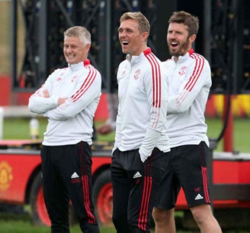 Manchester United legends Michael Carrick, Ole Gunnar Solskjaer, and Darren Fletcher in their playing days wearing the iconic red jersey