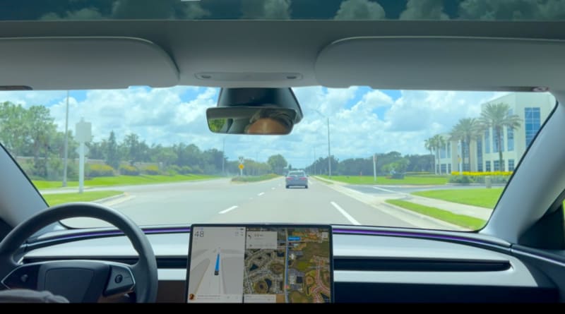 Tesla Model 3 electric vehicle driving on American highway demonstrating autonomous Full Self Driving technology capabilities