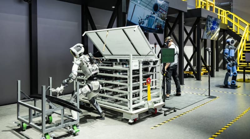 Hyundai IONIQ 5 RoboTaxi autonomous electric vehicle with robotic charging system at CES technology showcase