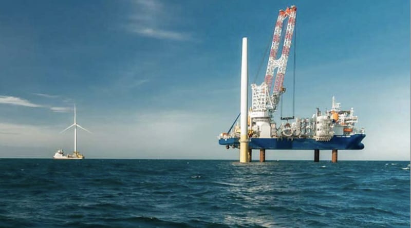 Massive offshore wind turbines rising from ocean waters off Virginia coast generating clean electricity