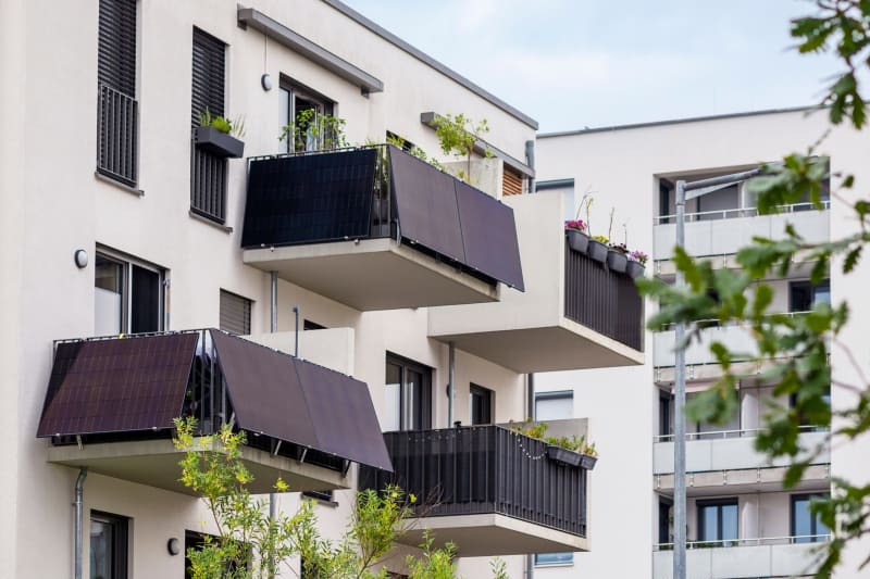 Compact solar panels mounted on apartment balcony railing capturing sunlight for clean energy