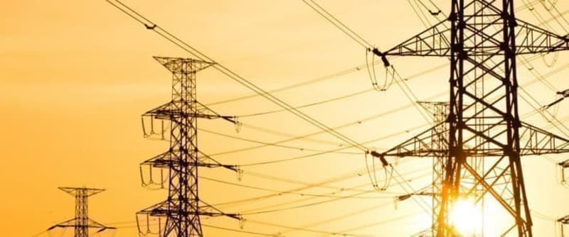 ** Large solar panel arrays stretching across Egyptian desert landscape under bright blue sky
