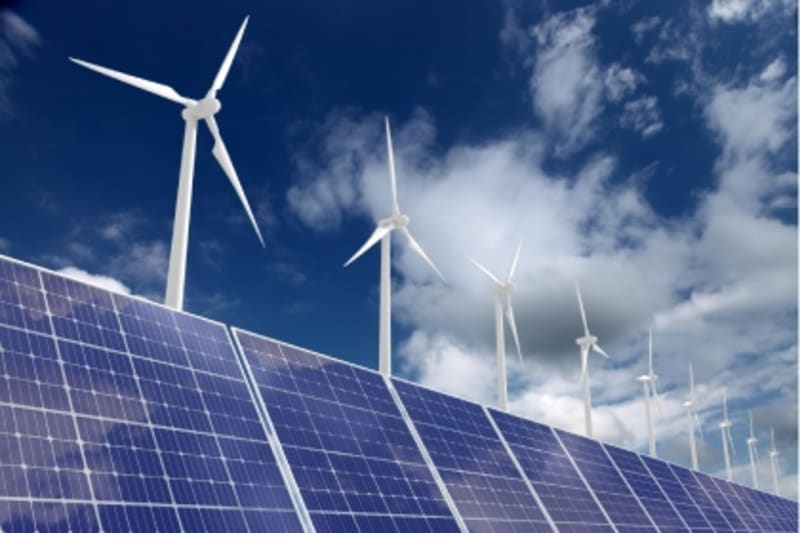 Wind turbines and solar panels generating clean electricity for German steel manufacturing facility