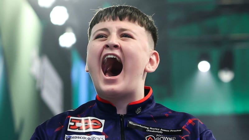 Teenage darts player Mitchell Lawrie celebrating after throwing a perfect nine-dart finish at tournament