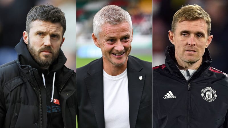 Ole Gunnar Solskjaer and Michael Carrick standing together at Old Trafford in Manchester United coaching attire, smiling warmly.