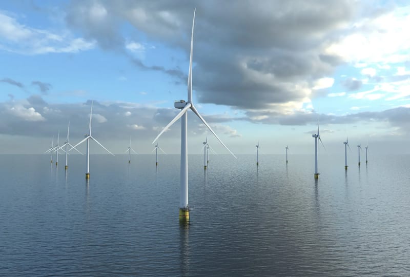 Offshore wind turbines rising from ocean waters under blue sky symbolizing European renewable energy