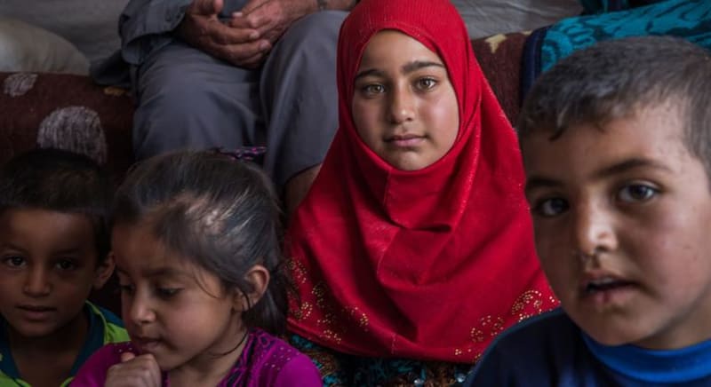 Iraqi families and children in their community, representing hope and renewal in post-conflict Iraq's remarkable development journey