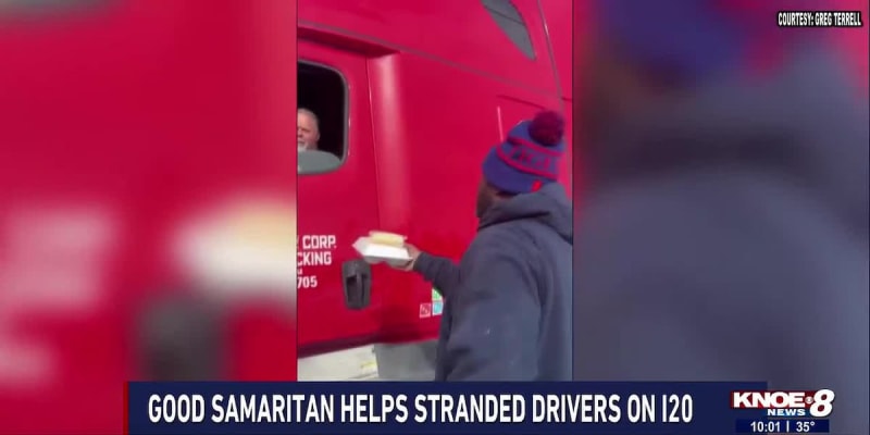 Man delivering supplies to cars stranded on snowy interstate highway in Louisiana