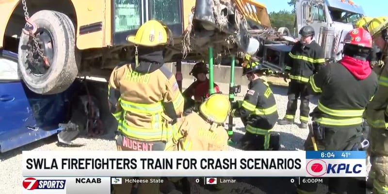 Firefighters in protective gear practicing rescue techniques on overturned bus during training exercise