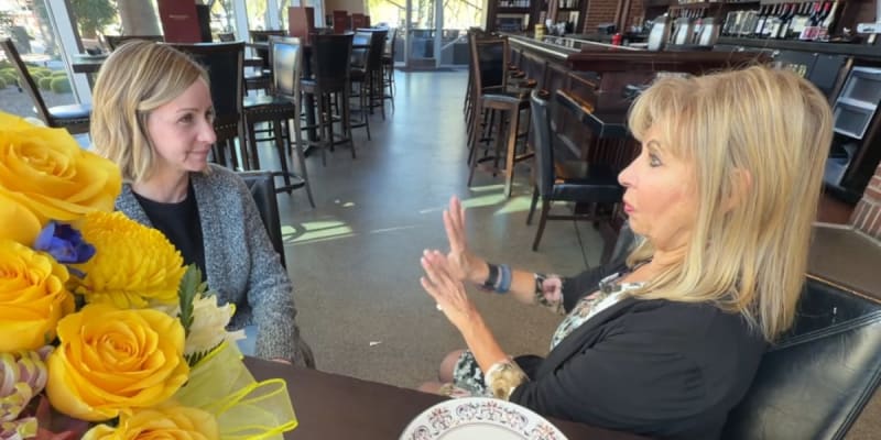 Three women smiling together, celebrating their bond formed after life-saving CPR at hockey game