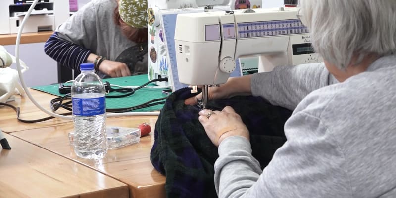 Volunteers help repair clothing and shoes at library Fix-It Fair event in Springfield Missouri