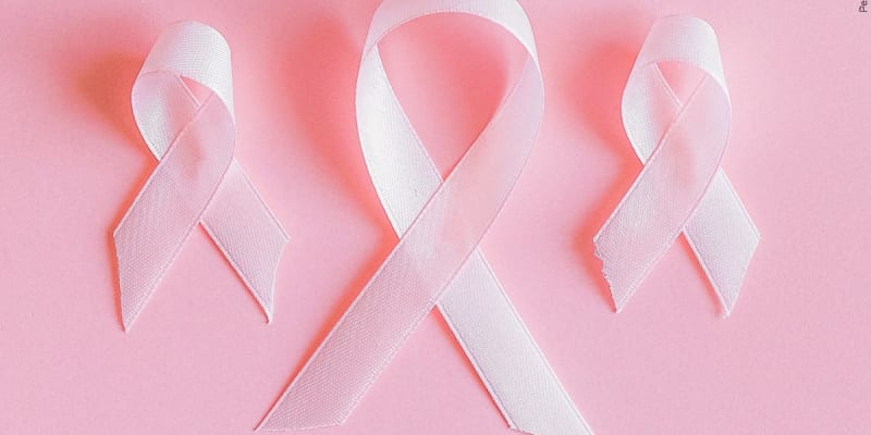 Women gathering together at outdoor wellness event for breast cancer survivors in natural setting