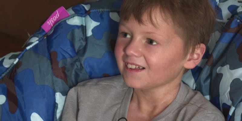 Young boy Liam Sanborn smiling outdoors, wearing casual clothes, representing hope for cancer survivors