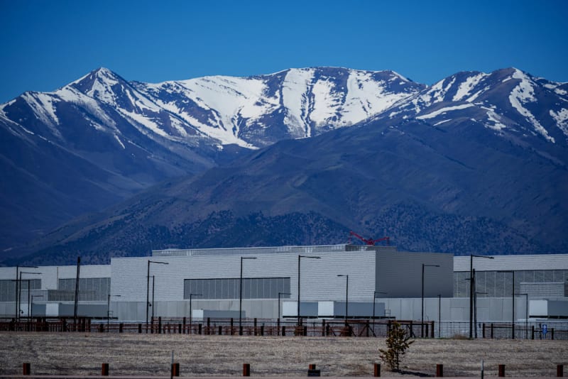Modern data center facility in Utah with desert mountains in background