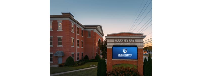 Two Drake State Community and Technical College students celebrating scholarship awards at workforce development summit