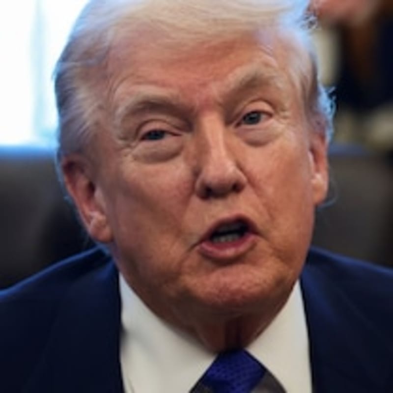 ** Ilia Malinin celebrates on podium holding gold medal at 2026 Milan Olympics